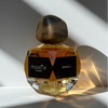 Perfume bottle labeled 'mood'or' with 'Neroli' on a light background